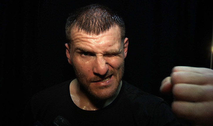 Stipe Miocic Holding His Fist Out To Camera.