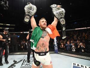 Conor Mcgregor With His Two Ufc Championship Belts.