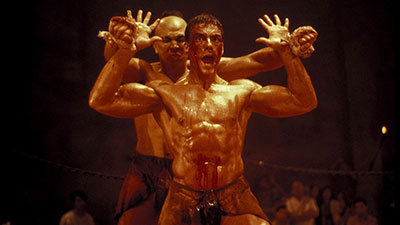 Eric Sloane Played By Jean Claude Van Damme Blocks An Attack By Tong Po In Kickboxer Fight Scene.