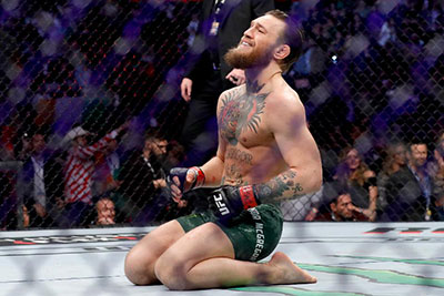 Conor Mcgregor On His Knees Celebrating His Win At Ufc 246.
